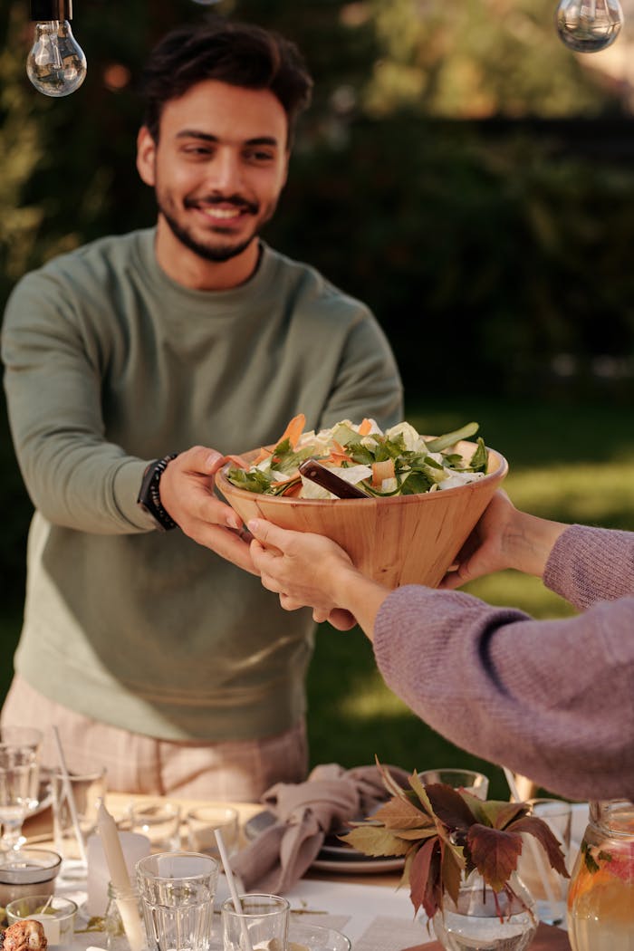 A Man Holding a Bowl of Salad